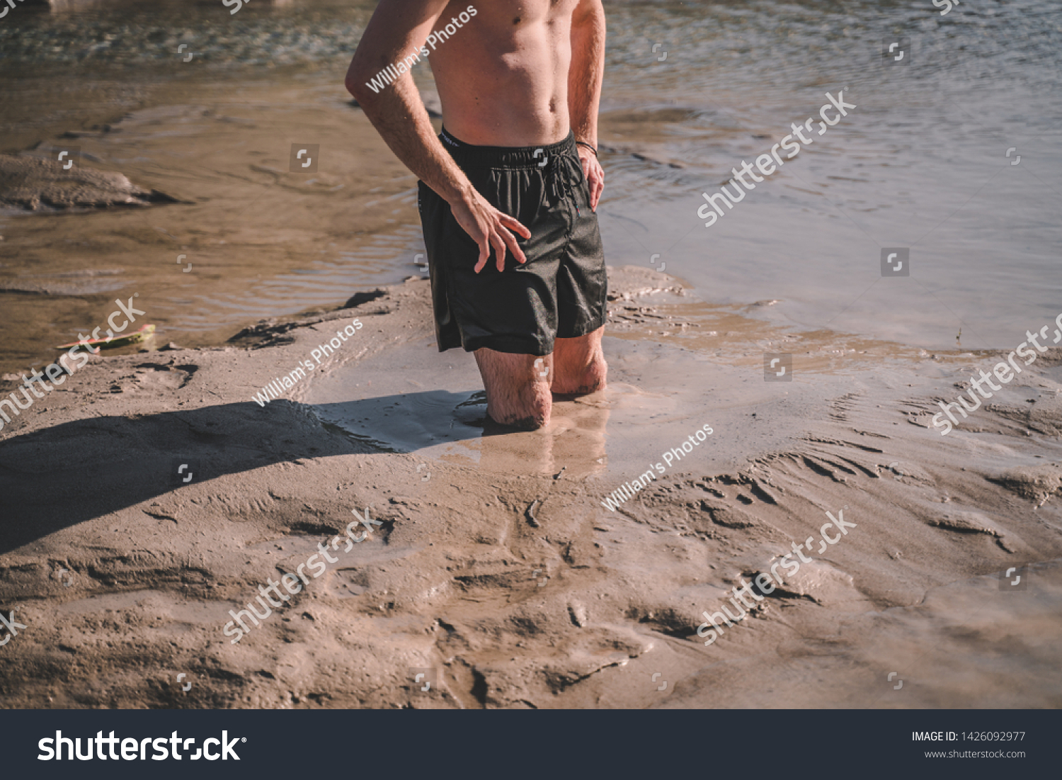 stock-photo-person-standing-in-natural-quicksand-river-clay-sediments-sinking-drowning-quick-sand-stuck-in-1426092977.jpg